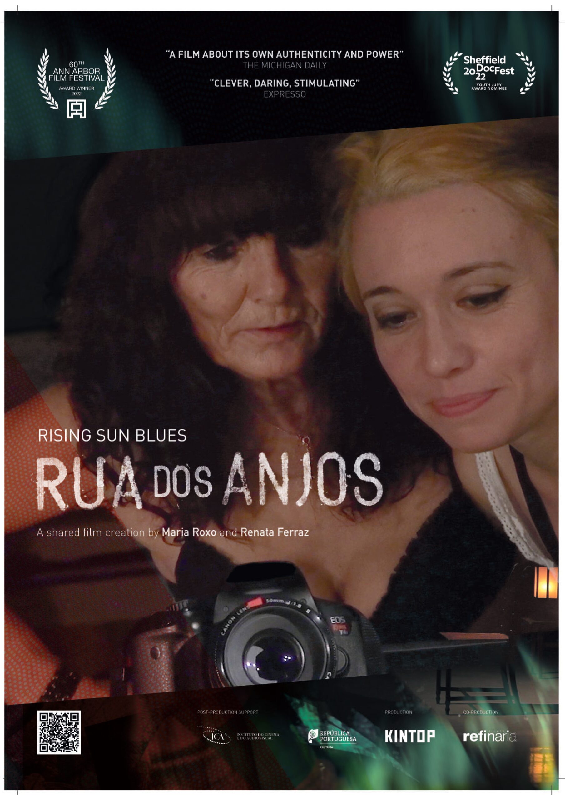 An older dark haired woman and a younger light haired woman appear on the film poster. A camera lens is in the foreground.